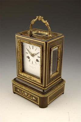 Appraisal: A th century French fruitwood and brass mounted mantel clock