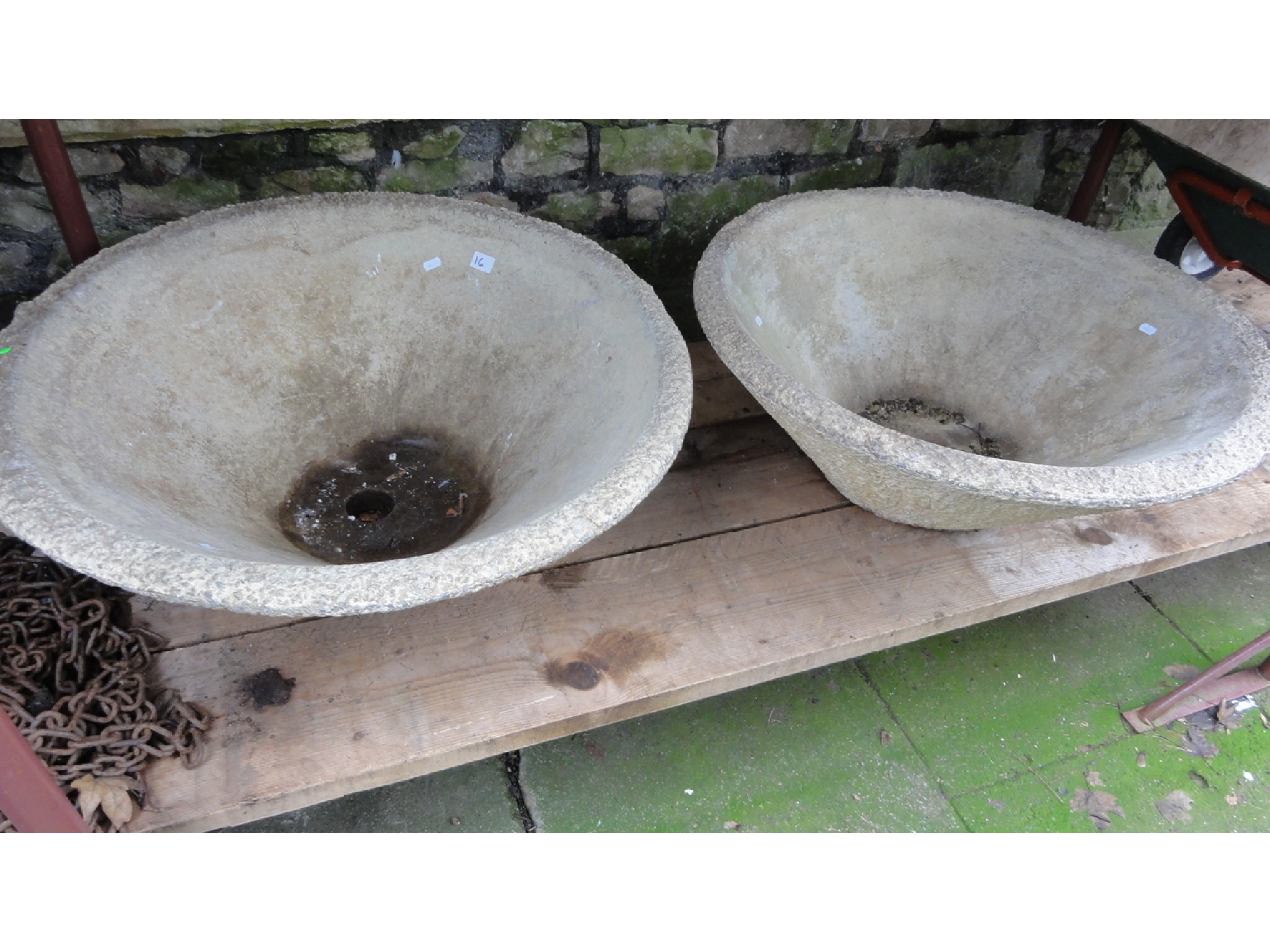 Appraisal: A pair of weathered cast composition stone garden planters of