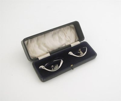 Appraisal: A modern cased pair of 'wishbone' napkin rings one with