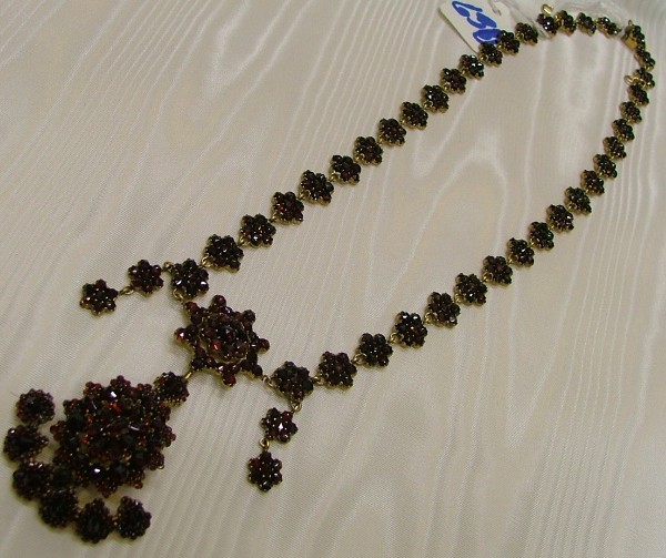 Appraisal: CZECHOSLOVAKIAN RED GARNET LAVALIERE length in of flower form having