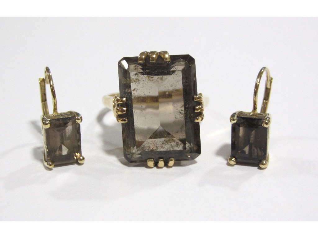 Appraisal: A nine carat gold step cut smokey topaz single stone