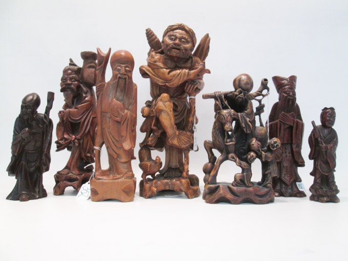 Appraisal: SEVEN CHINESE CARVED WOOD FIGURAL SCULPTURES including Immortals deities and