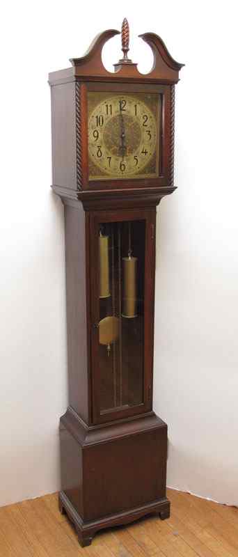 Appraisal: COLONIAL MFG MAHOGANY GRANDMOTHER CLOCK Mahogany case with broken arch