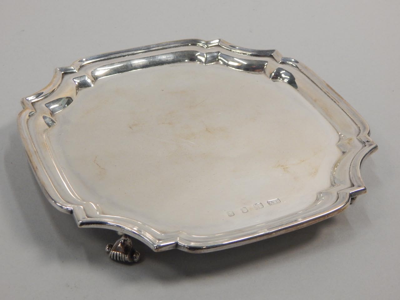 Appraisal: A silver waiter with canted corners and scroll cast feet