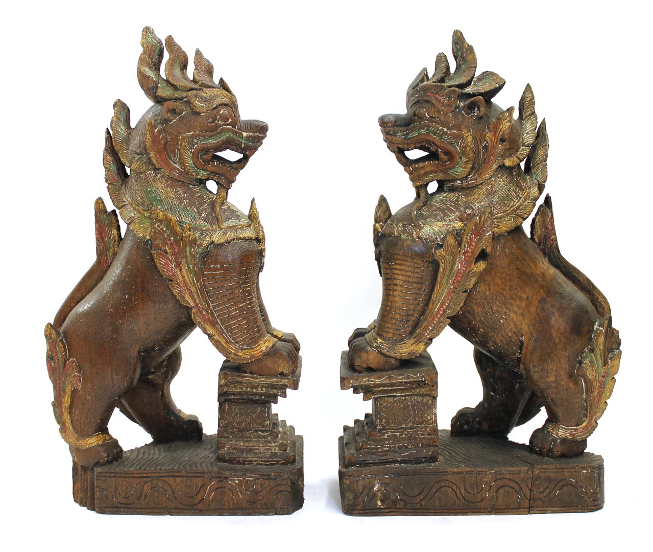 Appraisal: A pair of Thai painted wood temple lions th century