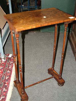 Appraisal: A rosewood occasional table the rectangular top upon turned end