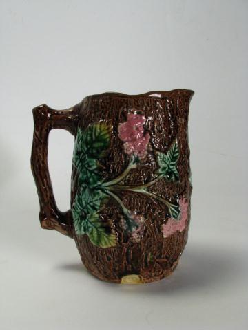 Appraisal: Majolica handled milk pitcher with leaf and floral motif inches