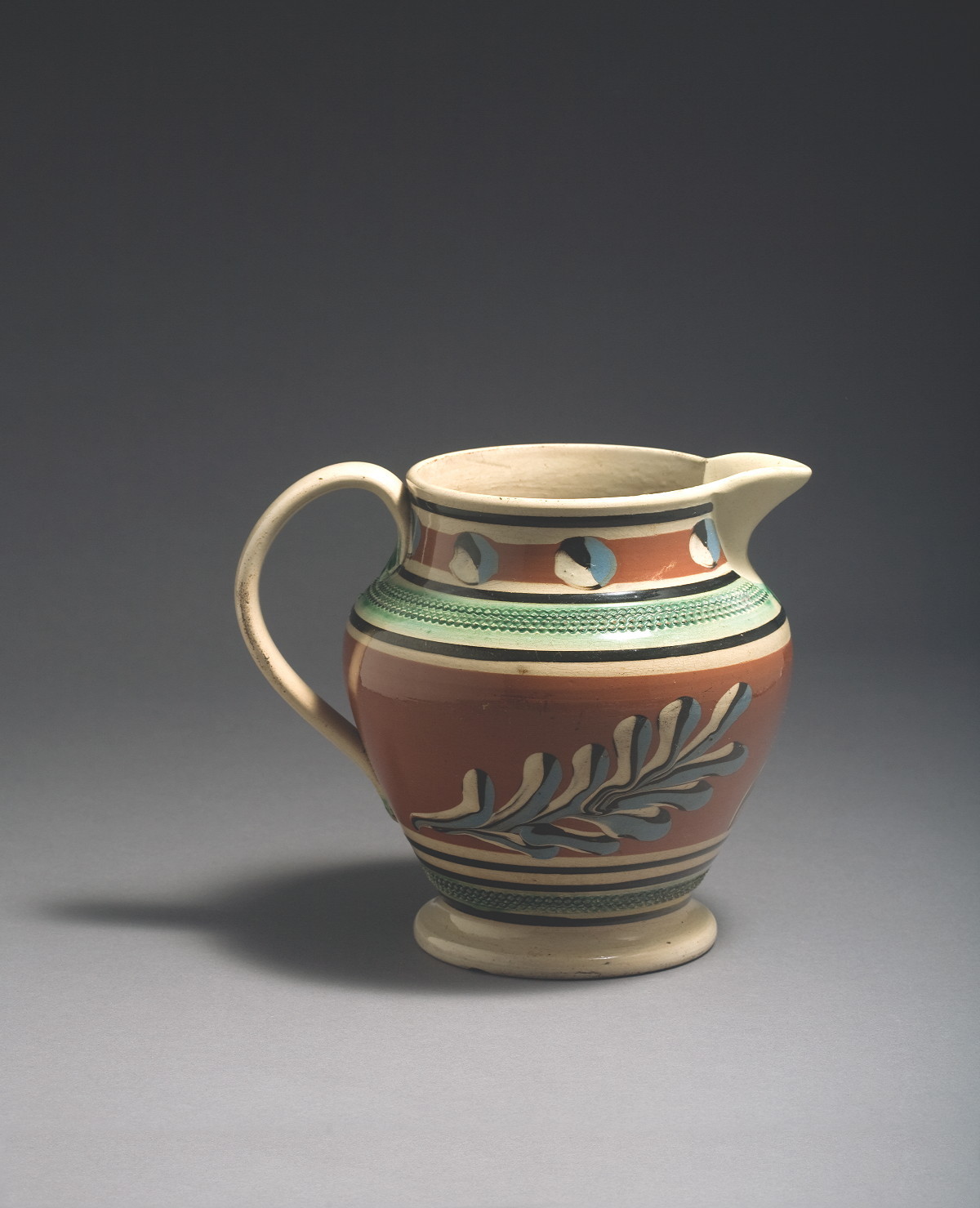 Appraisal: BRITISH PEARLWARE MOCHAWARE JUG CIRCA Of shouldered tapered form surrounded