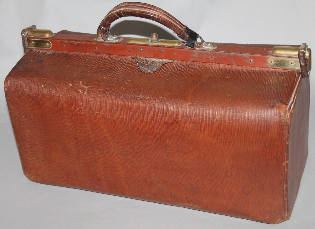 Appraisal: A mid thC pressed leather Gladstone bag with thumb mount