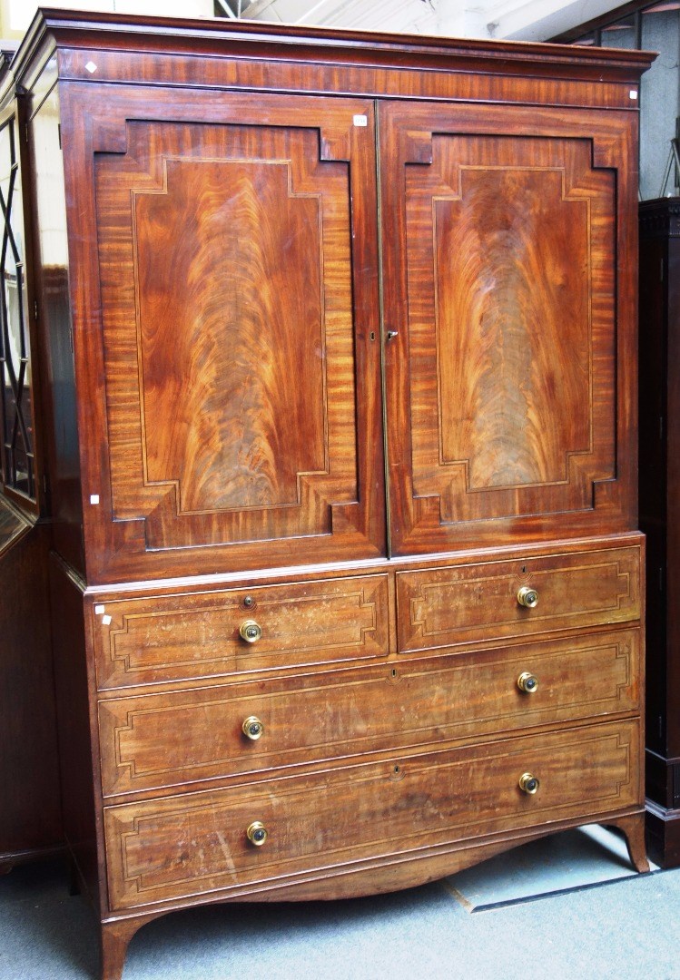 Appraisal: A George III mahogany linen press the pair of doors