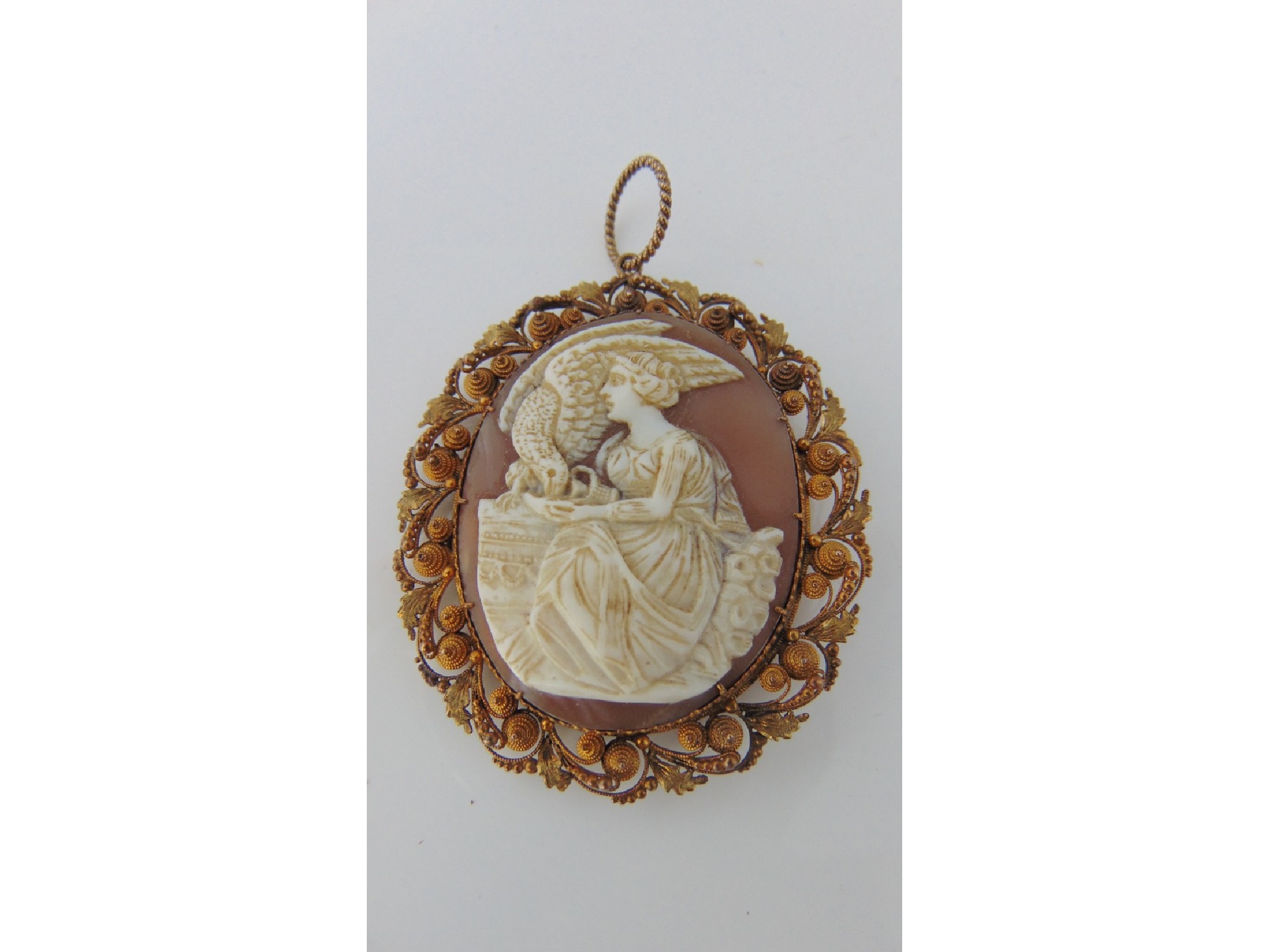 Appraisal: A cameo brooch the central carving depicting a lady feeding