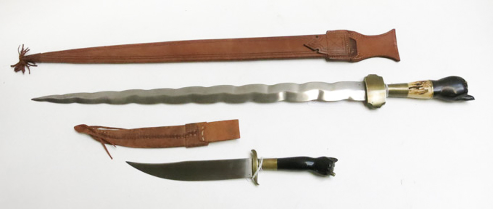 Appraisal: TWO EDGED WEAPONS WITH CARVED GRIPS the first a Kris