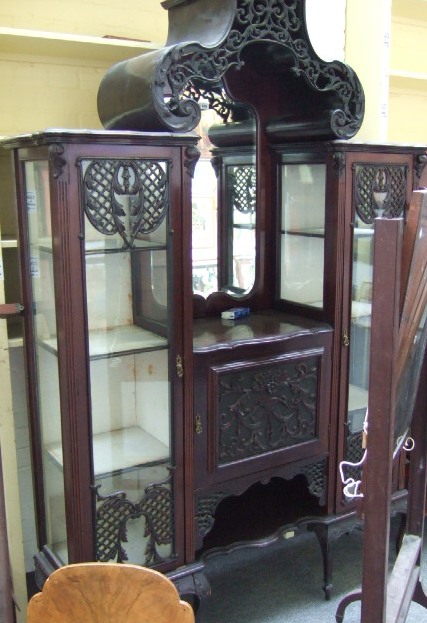 Appraisal: A late th century mahogany display cabinet with fret carved