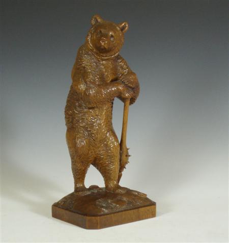 Appraisal: A Swiss 'Black Forest' carved wood bear guard holding a