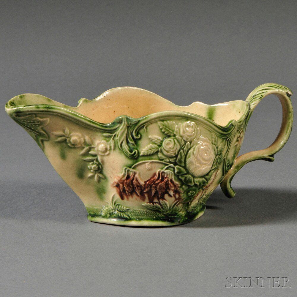 Appraisal: Staffordshire Cream-colored Earthenware Sauceboat England c translucent green and brown