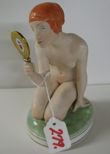 Appraisal: GERMAN BISQUE PORCELAIN FIGURE of nude female kneeling and holding