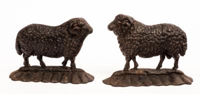 Appraisal: A near pair of cast iron doorstops modelled as sheep