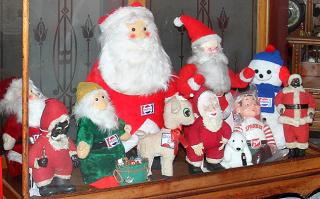 Appraisal: Group of advertising dolls and Santas Group of advertising dolls