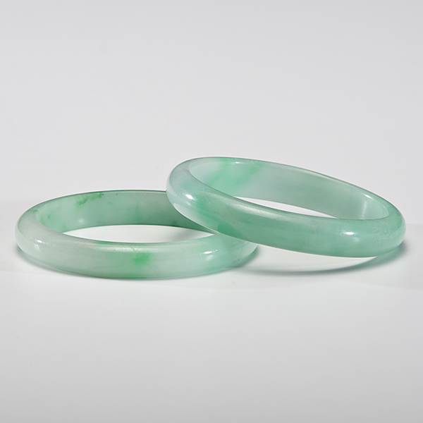 Appraisal: Chinese th century Two green jadeite bangles Dia in each