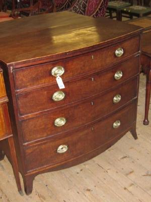 Appraisal: A GEORGE III MAHOGANY CHEST of bowed form with stringing