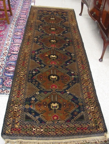 Appraisal: PAKISTANI BELOUCH RUNNER hand knotted in a pattern comprising a