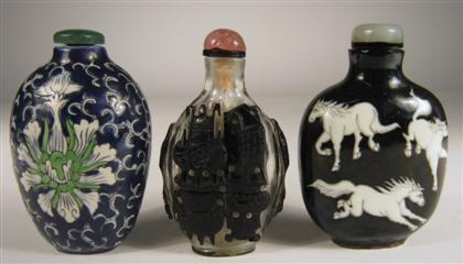 Appraisal: Three Chinese snuff bottles Comprising a clear glass ovoid bottle