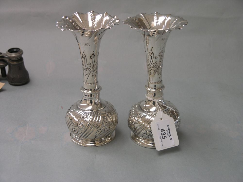 Appraisal: A pair of late Victorian embossed silver vases with flared