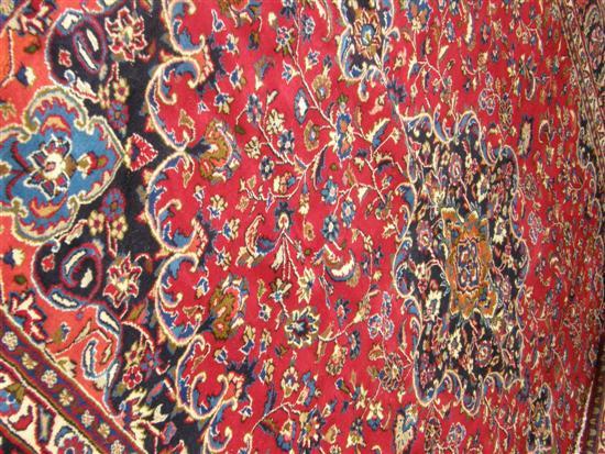 Appraisal: Red ground Persian carpet with a main blue ground border