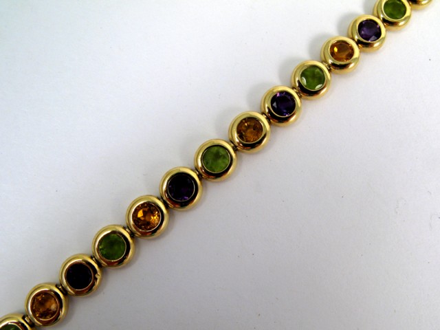 Appraisal: AMETHYST CITRINE AND PERIDOT BRACELET The k yellow gold bracelet