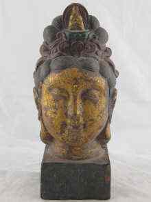 Appraisal: A gilt metal Tibetan Buddha head the square plinth with