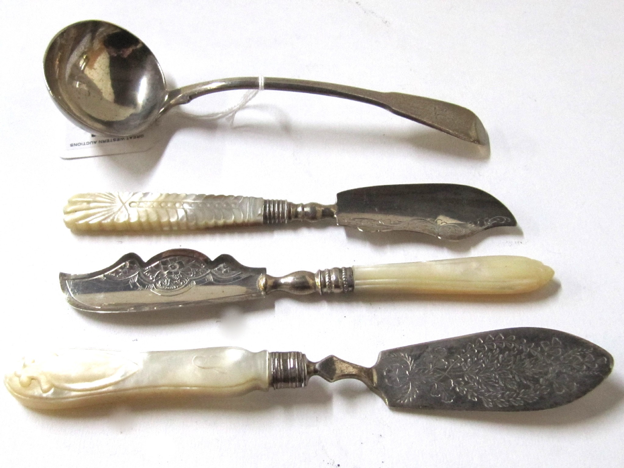 Appraisal: A lot comprising three silver and mother of pearl butter