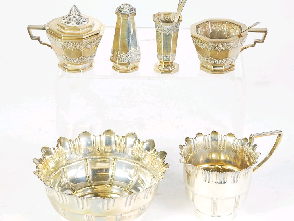 Appraisal: THREE PIECE BURMESE SILVER COLOURED METAL CONDIMENT SET panelled with