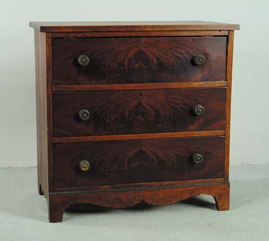 Appraisal: DIMINUTIVE MAHOGANY THREE-DRAWER ANTIQUE CHEST Applied bracket front with shaped