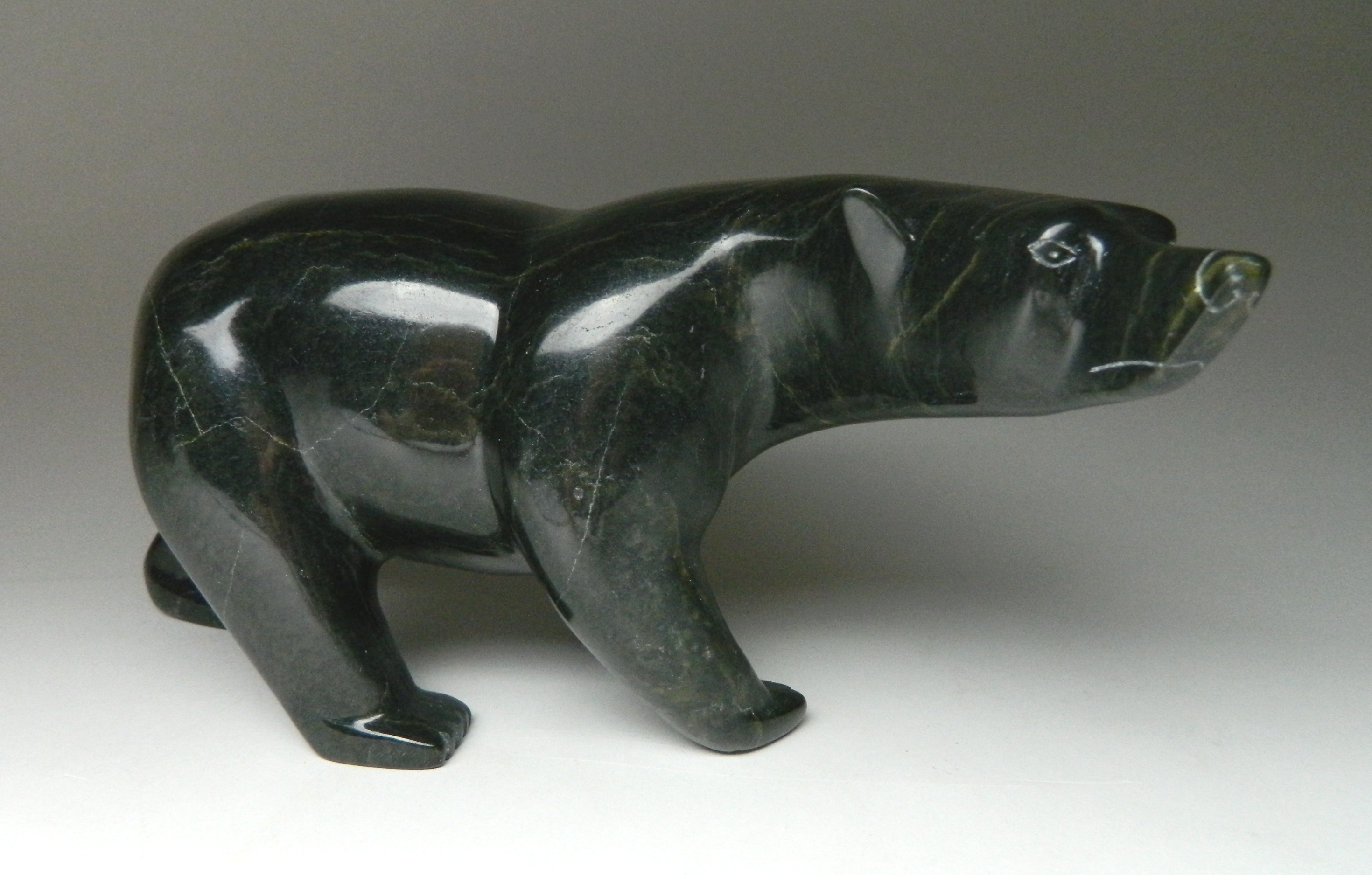 Appraisal: Jimmie Petooloosie Cape Dorset Walking Bear- stone carving signed x