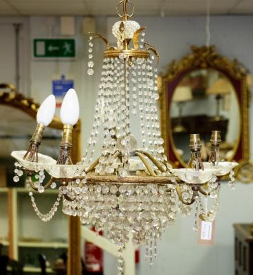 Appraisal: A five-branch chandelier hung with swags of prismatic drops a