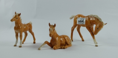 Appraisal: Beswick large Palamino foal head down Palamino lying foal and