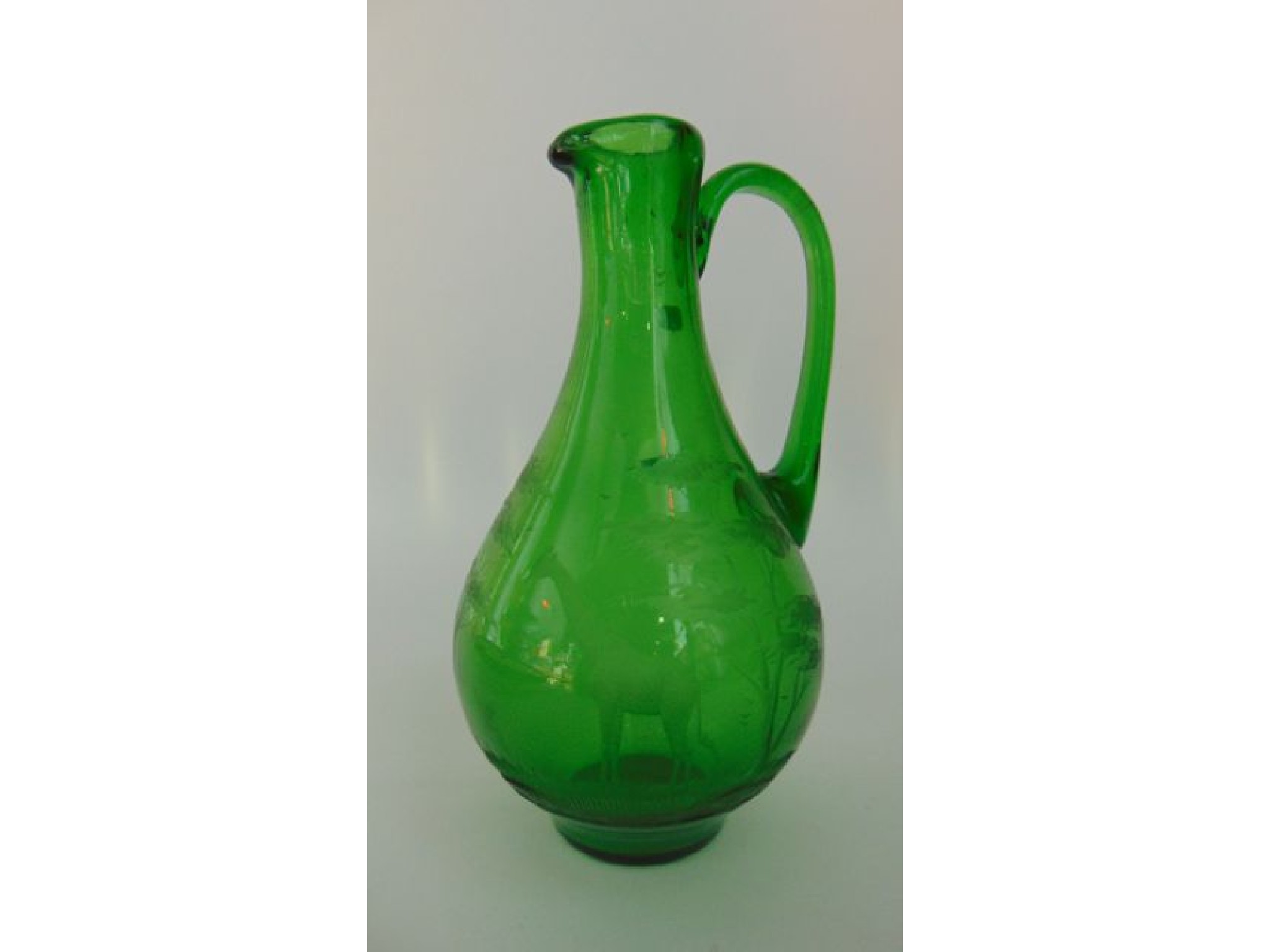 Appraisal: An emerald green glass ewer designed by Rowland Ward in