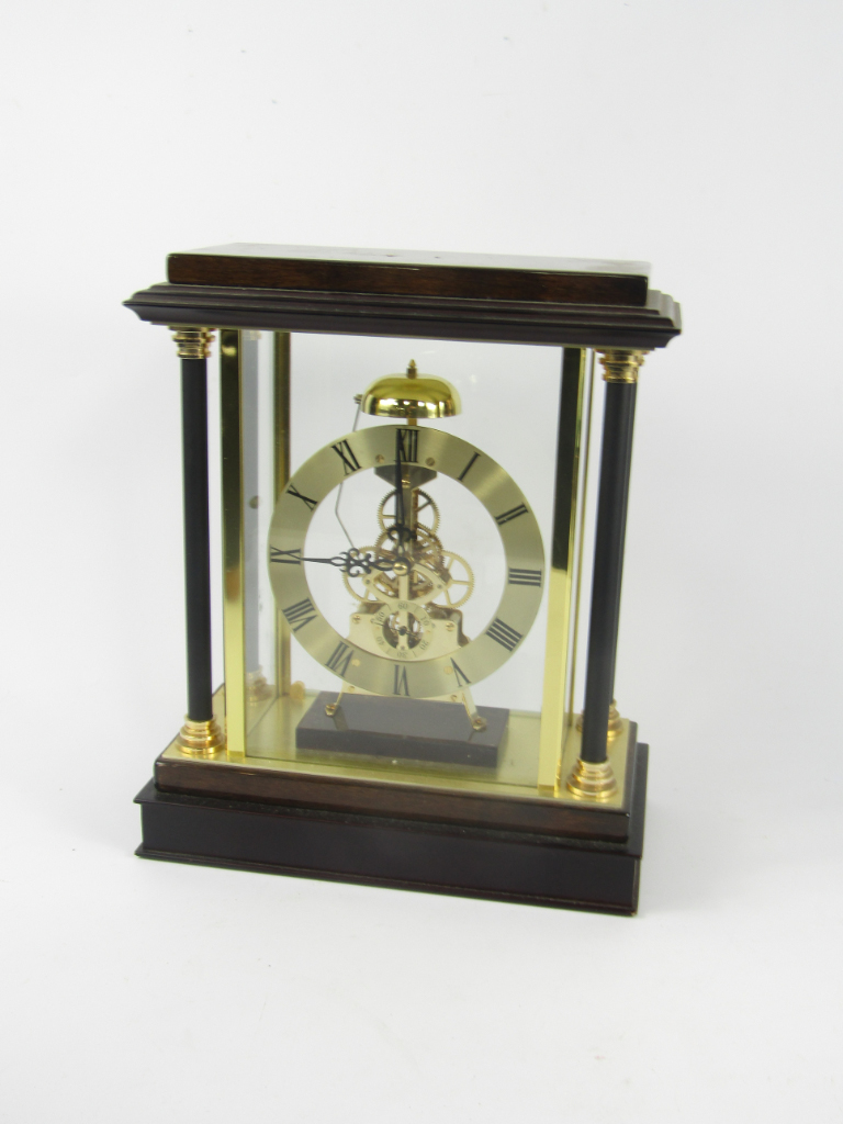 Appraisal: A wooden and brass cased skeleton clock of architectural form