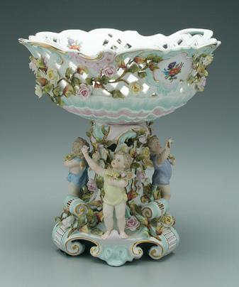 Appraisal: Figural porcelain center bowl surface encrusted with flowers and vines