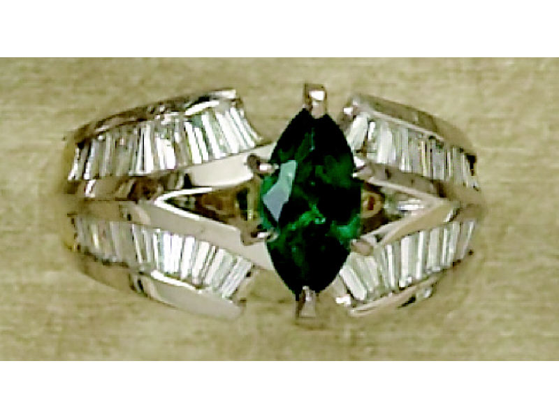 Appraisal: EMERALD AND DIAMOND RING k yellow gold channel set ring