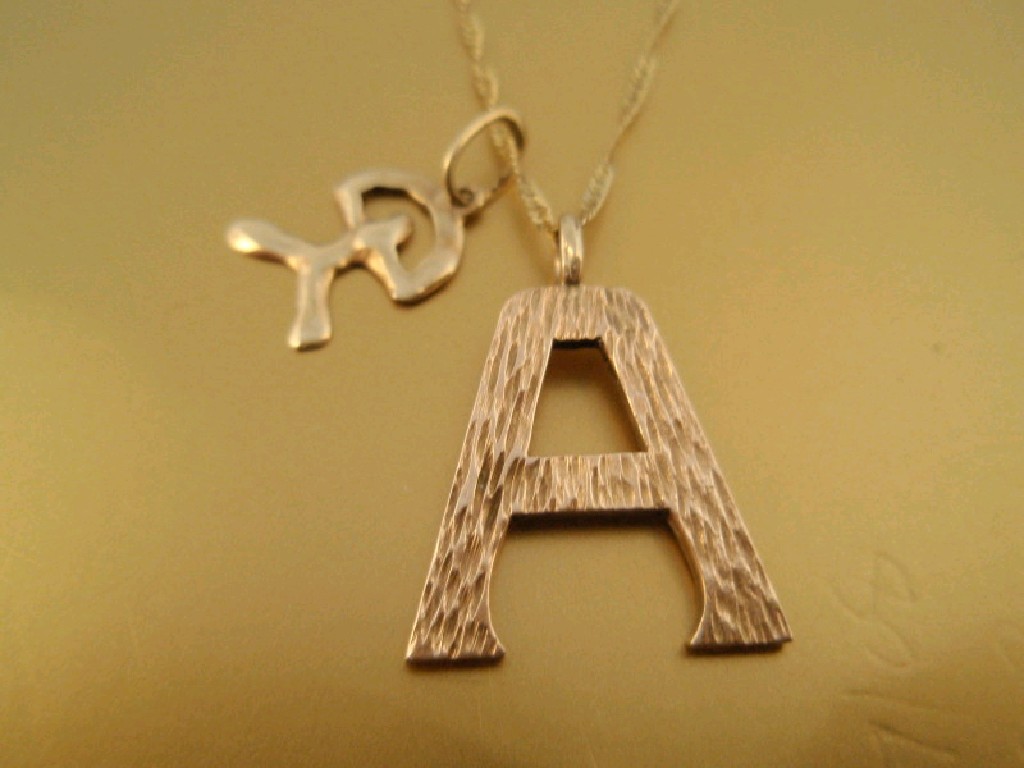 Appraisal: A letter A pendant and chain stamped ct