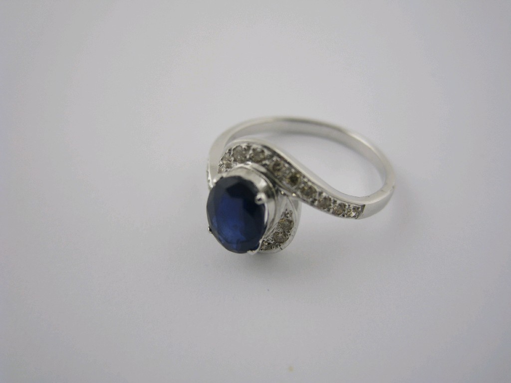 Appraisal: A Sapphire and Diamond Cluster Ring the oval-cut sapphire claw-set