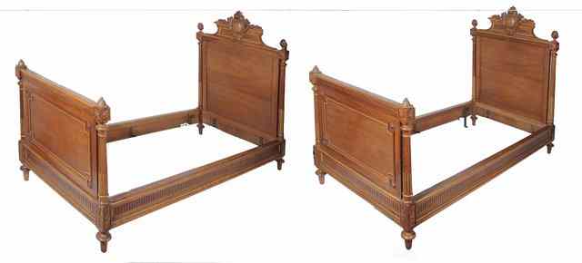 Appraisal: A PAIR OF FRENCH BEECH OR WALNUT SINGLE BEDSTEADS with