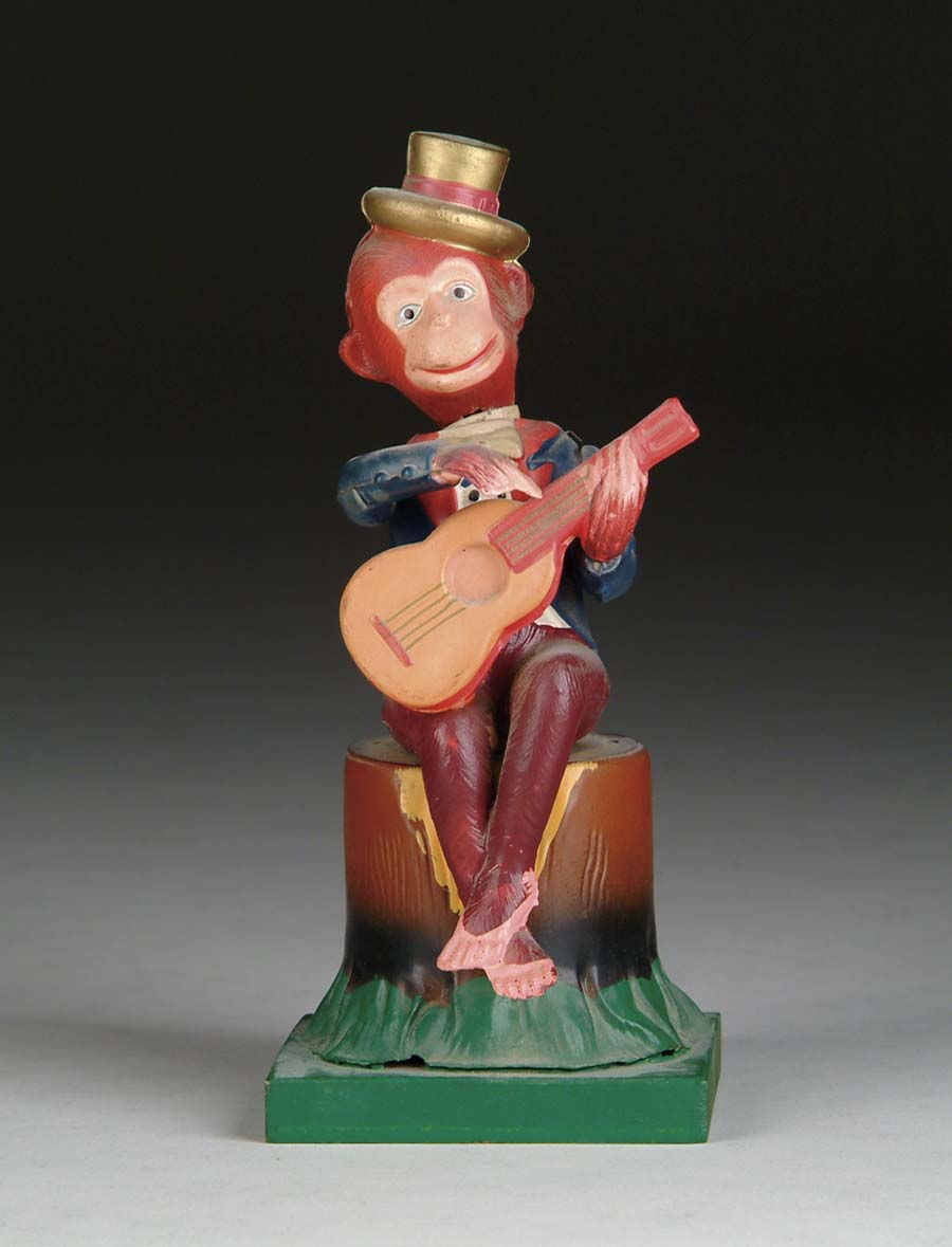 Appraisal: CELLULOID MONKEY WITH GUITAR Wind-up occupied Japan Hand-painted celluloid monkey