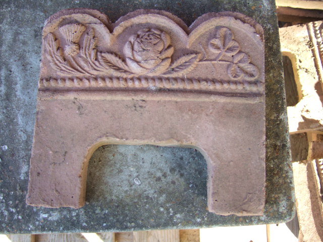 Appraisal: A quantity of terracotta edging tiles moulded with thistles roses