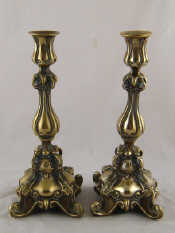 Appraisal: A pair of ornate formed brass European candlesticks ht cm