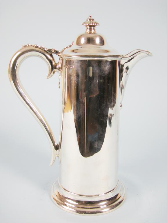 Appraisal: A Victorian Flagon of straight form with hinged domed cover