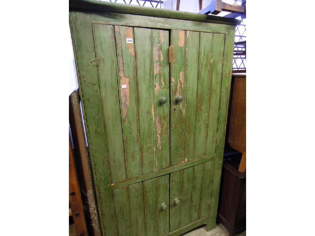 Appraisal: A rustic painted pine freestanding side cupboard enclosed by two