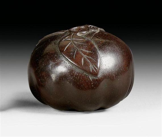 Appraisal: A WOODEN NETSUKE OF A KAKI WITH TWO GO PLAYING