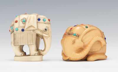 Appraisal: Two Carved Ivory Elephants Recumbent elephant netsuke possibly stained having